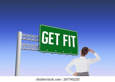 The word get fit and businesswoman scratching her head against blue and purple sky - Powered by Shutterstock