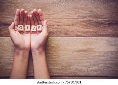 The word "GIVE" in hands in cupped shape. Concepts of sharing, giving,  - Shutterstock ID 769307881