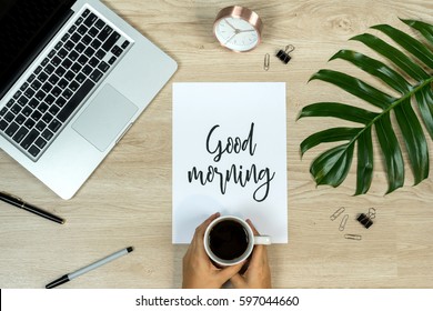 Word Good Morning. Flat Lay, Top View Office Table Desk. Workspace With Laptop, Coffee Cup And Clips On Wooden Background.