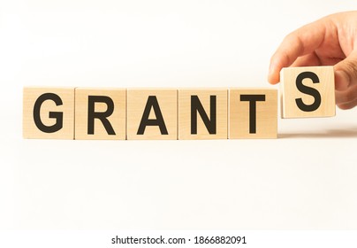 Word grants. Wooden small cubes with letters isolated on white background with copy space available.Business Concept image. - Shutterstock ID 1866882091