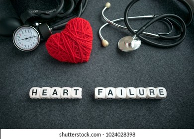 Word HEART FAILURE From White Cubes With Letters On Dark Background With Red Thread Heart And Tonometer. HEART FAILURE Inscription With Medical Equipment For Heart Diagnostics, Stethoscope