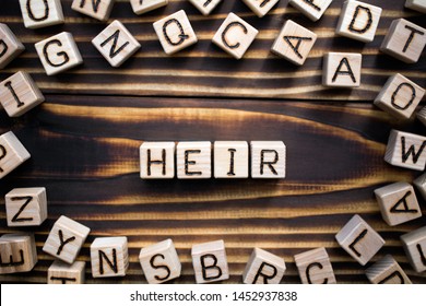 word heir composed of wooden cubes with letters, someone who continues or receive money property or a title concept, scattered around the cubes random letters, top view on wooden background - Shutterstock ID 1452937838