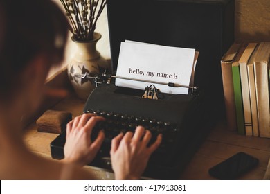 The Word Hello, My Name Is Against Young Woman Using Typewriter