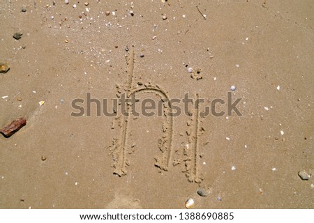 Word Hi written on wet sand. Summer beach background, sea vacation.