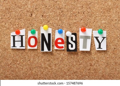 The word Honesty in cut out magazine letters pinned to a cork notice board. We look for honesty in our dealings with people in both our personal and professional lives.