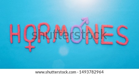 The word hormones from red plasticine on a blue background concept of all human hormones, inscription Stock photo © 