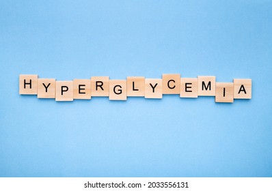 Word 'hyperglycemia' on wooden blocks on blue background