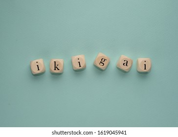 word IKIGAI on wooden cubes on a blue background