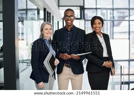 The word impossible doesnt exist in our work. Portrait of a group of businesspeople working together in a modern office.