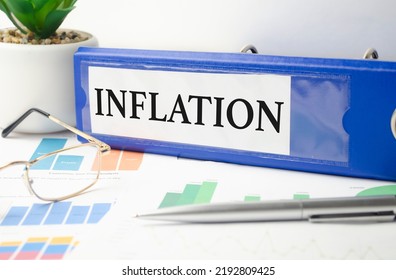 Word Inflation On Blue File Folder And Charts