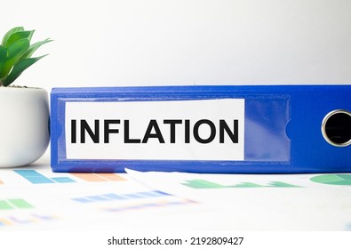 Word Inflation On Blue File Folder And Charts