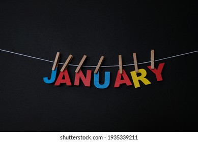 Word January On Black Background. January Is The First Month Of The Year In The Julian And Gregorian Calendars. 