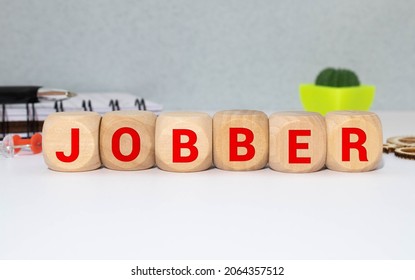 word JOBBER on wooden block
