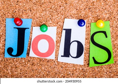 The word Jobs in cut out magazine letters pinned to a cork notice board