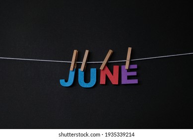 Word June On Black Background. June Is The Sixth Month Of The Year In The Julian And Gregorian Calendars.