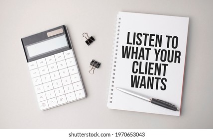 The word LISTEN TO WHAT YOUR CLIENT WANTS is written on a white background next to a pen ,calculator and reports. Business concept - Shutterstock ID 1970653043