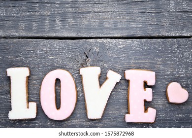 Word Love by cookies on grey wooden table