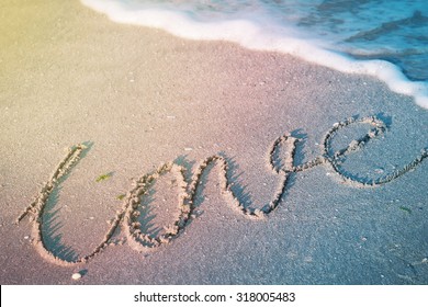 The Word Love On Beach With Wave