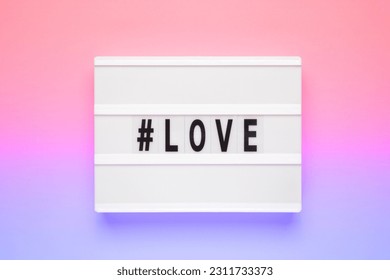 The word love on lightbox isolated pink background. Happy Valentines day concept. Romantic flat lay composition - Shutterstock ID 2311733373