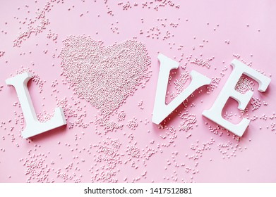 The word love in white letters on a trendy pink background. Happy Valentine's Day, Mother's Day, March 8, World Women's Day holiday card concept. Flat lay.  - Shutterstock ID 1417512881
