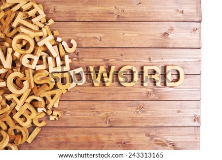 Word word made with block wooden letters next to a pile of other letters over the wooden board surface composition