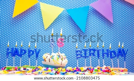 A word made from the letters of happy birthday candles for a sixteen year old. Copy space Happy birthday greetings for 16 years old, lit candles with holiday decorations. Beautiful holiday card.