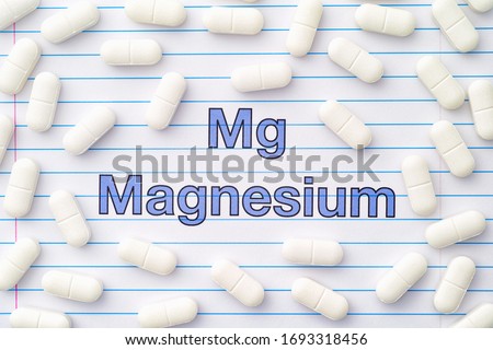 The word magnesium and magnesium tablets around it. Close up. Stock photo © 