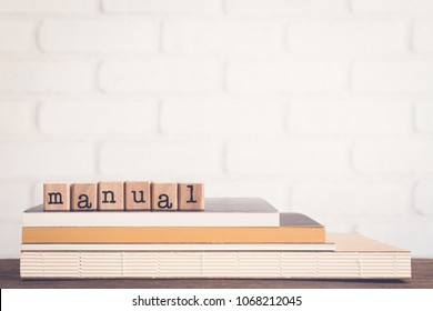 The word Manual, text on wooden cubes on top of books. Background copy space, vintage minimal style. Concepts of help information, Instructions or user guide for education and business products. - Shutterstock ID 1068212045