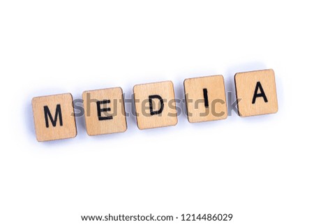 The word MEDIA, spelt with wooden letter tiles over a plain white background. 