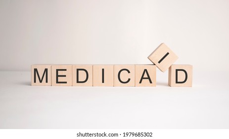 The Word Medicaid Is Written On Wooden Cubes On A Light Background. Business Concept