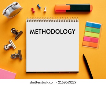 The word methodology written on a notebook on business office desktop. System of methods used in a study or activity concept. - Shutterstock ID 2162063229