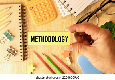 The word methodology written on a notebook on business office desktop. System of methods used in a study or activity concept. - Shutterstock ID 2206828965