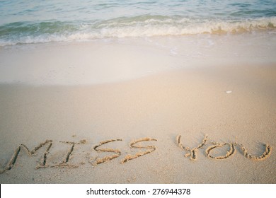 The Word Miss You Written In Sand On Beach 