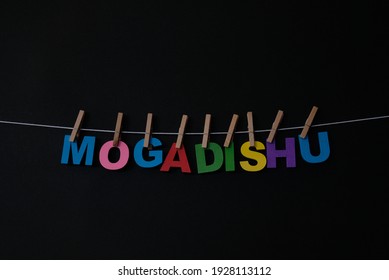 Word Mogadishu On Black Background. Mogadishu, Locally Known As Xamar Or Hamar, Is The Capital City  Of Somalia.  . 