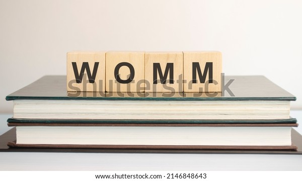 Word of Mouth Marketing word written on\
wooden blocks on a brown\
background.