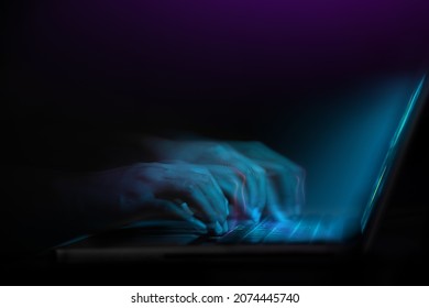 Word of Mouth, Power on the Internet Concept. Motion Blurred image of Hand Using Computer Laptop Keyboard on Desk in Dark Room. Working Fast at Night - Shutterstock ID 2074445740