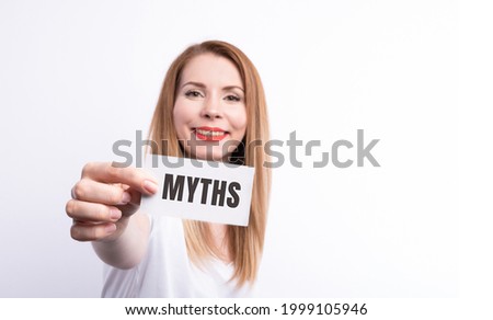 The word myths young woman holding blank card against white background with vignette