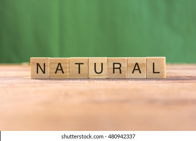 the word of NATURAL on wood tiles concept