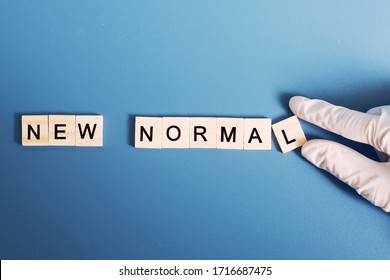 The Word Of New Normal And Abnormal With Human's Finger.Concept Of New Normal Behavior After Coronavirus Covid-19 Concept.