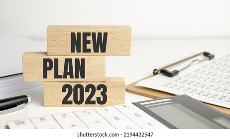 word new plan 2023 on wooden block and office supplies - Shutterstock ID 2194432547