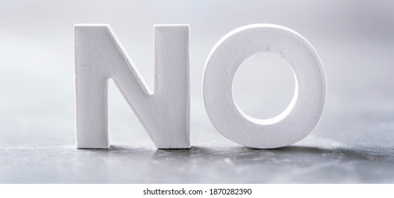 Word NO Made With Cement Letters On Grey Marble Background. Copy Space. Business Concept.