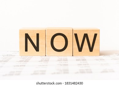 Word now. Wooden small cubes with letters isolated on white background with copy space available.Business Concept image.