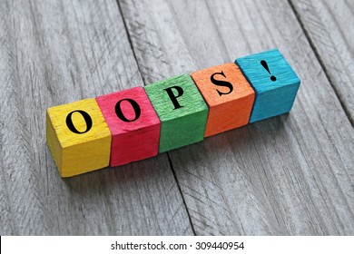 word oops on colorful wooden cubes