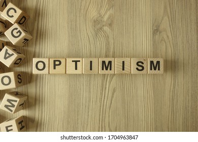 Word optimism from wooden blocks on desk - Shutterstock ID 1704963847