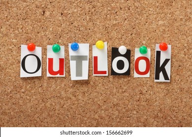 The Word Outlook In Cut Out Magazine Letters Pinned To A Cork Notice Board. Outlook May Apply To The Weather Forecast, The Economy Or Your Point Of View And Attitude To Life.