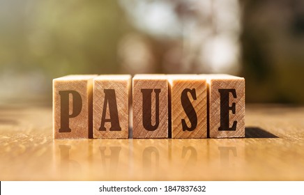The word pause with wooden blocks on the table in the sunlight. - Shutterstock ID 1847837632
