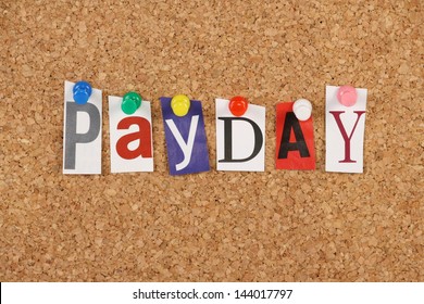 The word Payday in cut out magazine letters pinned to a cork noticeboard.