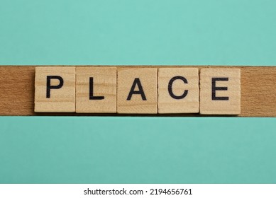 word place made of small gray wooden letters on a green paper background - Shutterstock ID 2194656761
