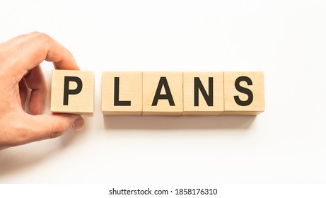 Word plans. Wooden small cubes with letters isolated on white background with copy space available.Business Concept image. - Shutterstock ID 1858176310