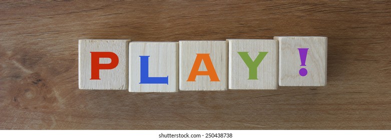 The Word PLAY! In Colors On Wood Blocks